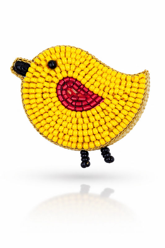 Yellow handcrafted bird brooch with red embroidered belly and gold trim on white background - Little Pink Llama