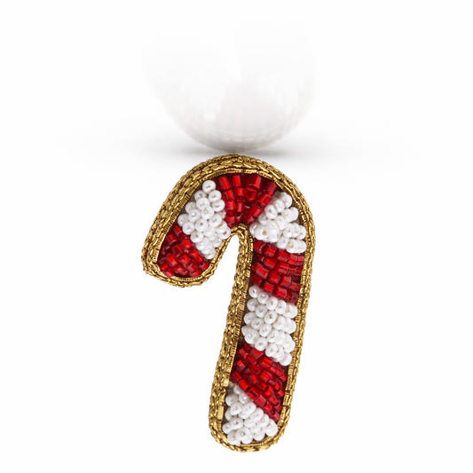 Close-up of handmade beaded candy cane hair clip with red and white seed beads and gold border – festive holiday hair accessory