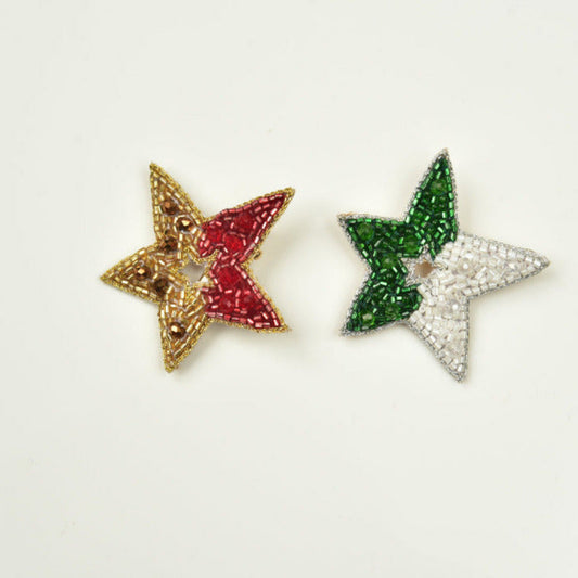 Both red-gold and green-white handmade guiding star brooches on white background - Little Pink Llama