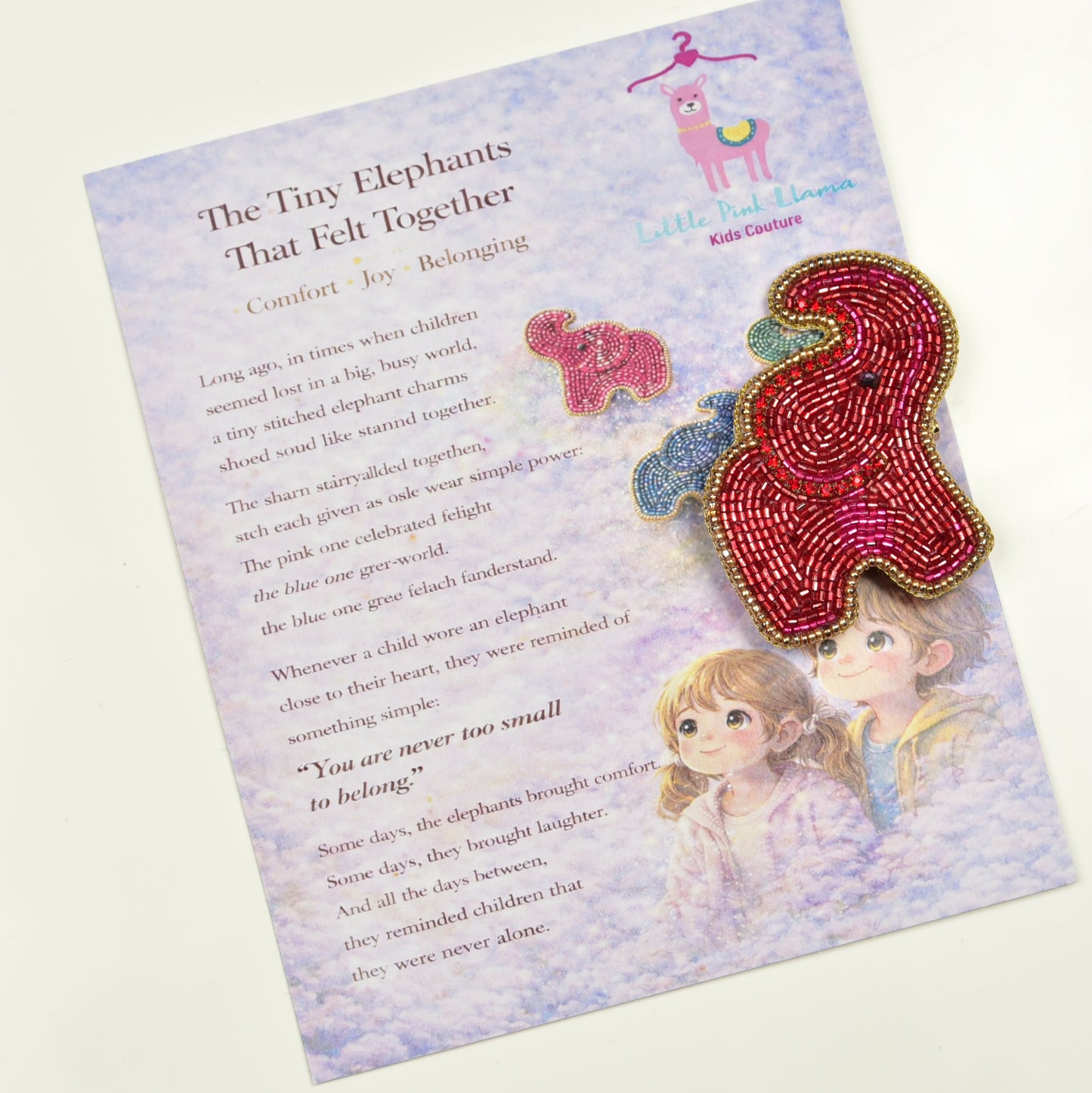 Red beaded elephant hair clip from Little Pink Llama displayed on a children's storybook card - handmade accessory gift packaging