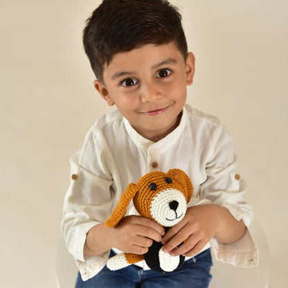 Young boy holding handmade crochet dog stuffed animal - showing size and appeal as perfect gift toy for children