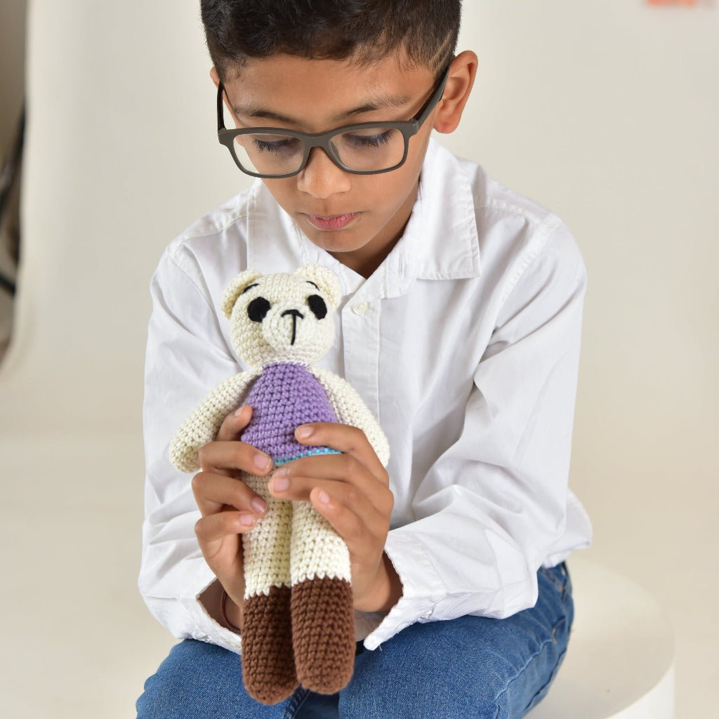 Child holding a handmade crochet teddy bear toy, showing the soft and huggable cotton stuffed bear perfect for kids