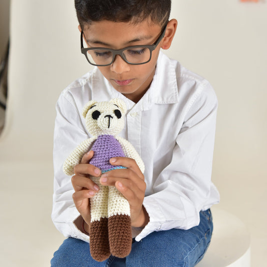 Child holding a handmade crochet teddy bear toy, showing the soft and huggable cotton stuffed bear perfect for kids