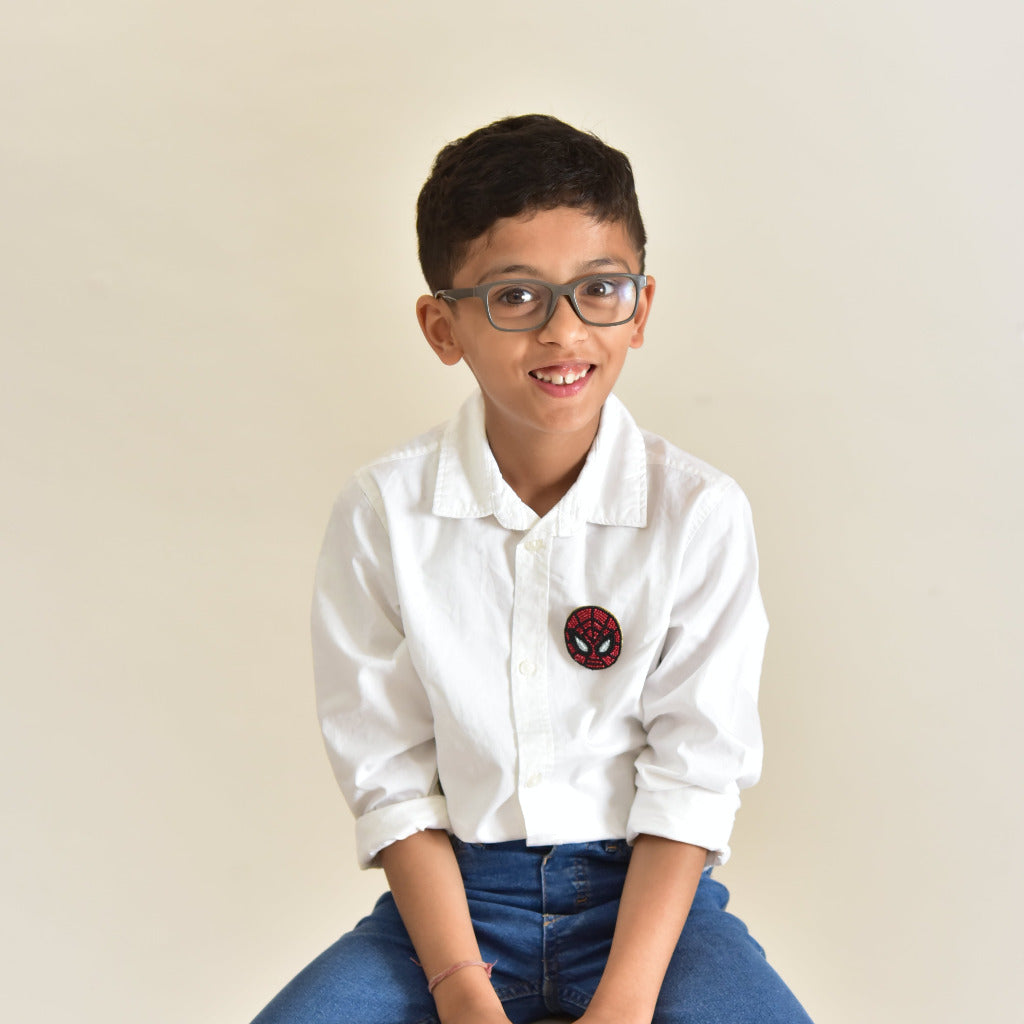 Spider-Man beaded brooch displayed on a smart boy showing detailed red and black beadwork