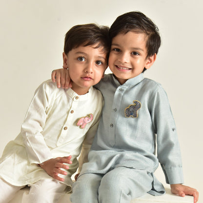 Two children wearing handcrafted beaded elephant brooches on traditional Indian outfits—kids jewelry by Little Pink Llama