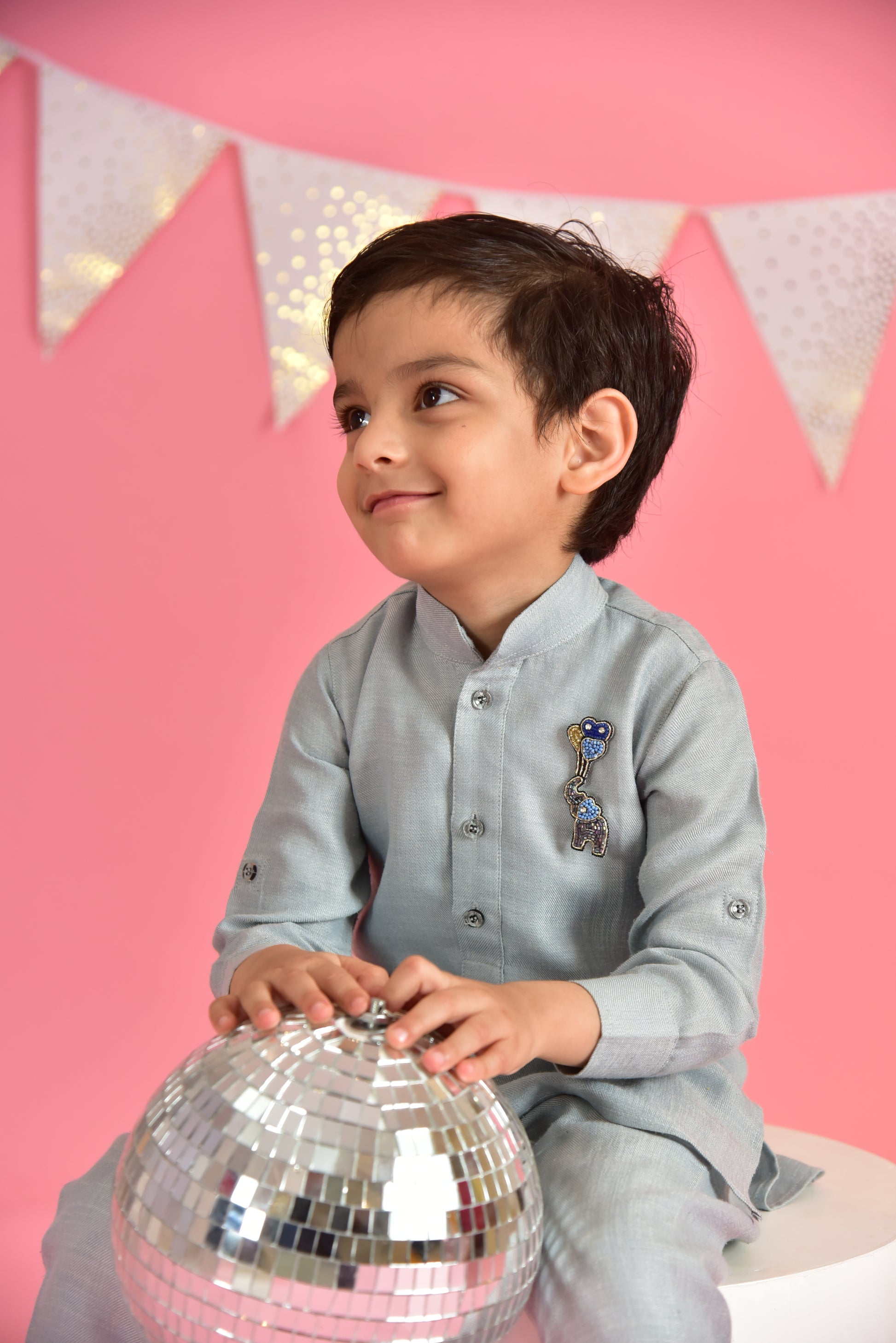Child in gray kurta wearing handmade elephant with balloons brooch holding disco ball – Little Pink Llama festive kids brooch