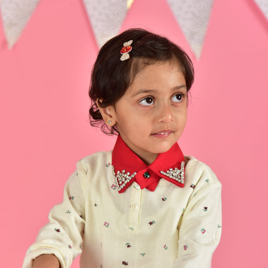 Young girl wearing candy hair clip with red collar shirt against pink party background - kids hairclip