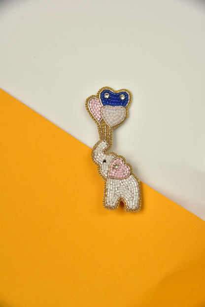 White elephant with balloons handmade brooch on yellow and white background – artisan beaded lapel pin by Little Pink Llama