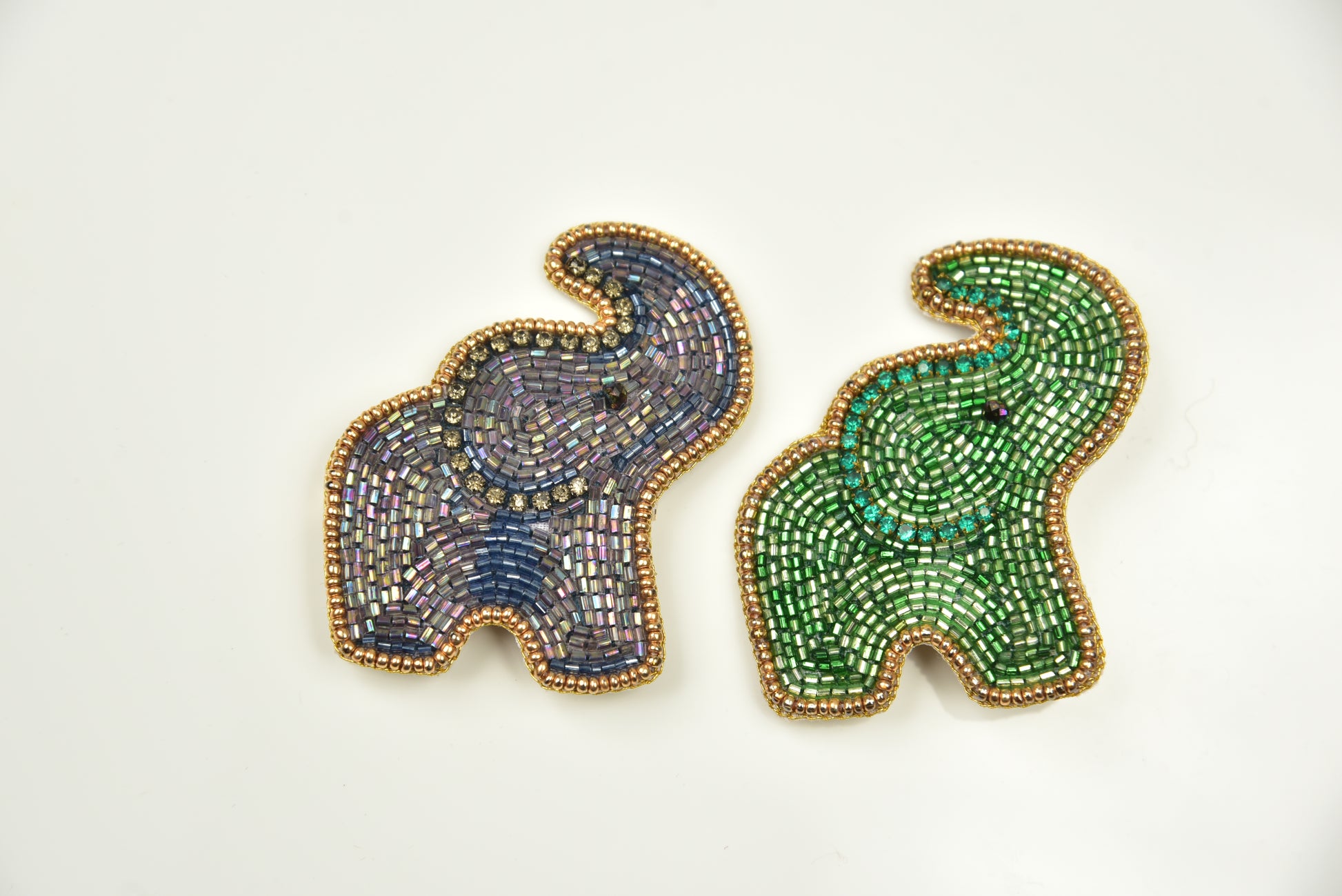 Gray and green handcrafted beaded elephant brooches with gold border on white background—kids jewelry collection by Little Pink Llama