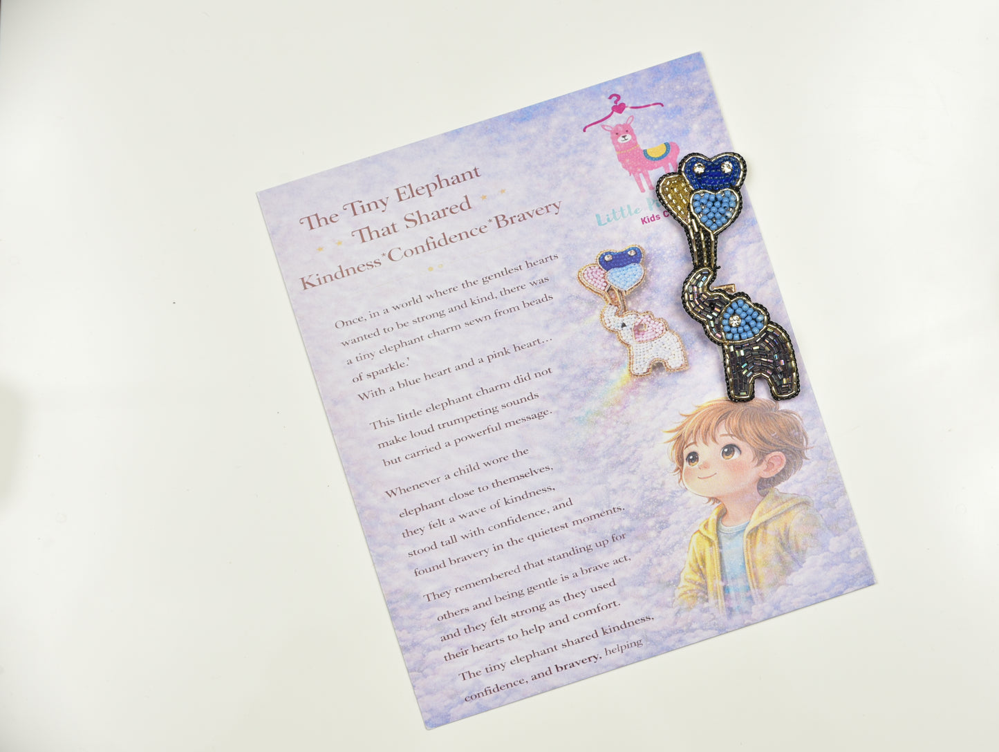 Both gray and white elephant with balloon hair clip variants on storybook packaging - handmade kids clips